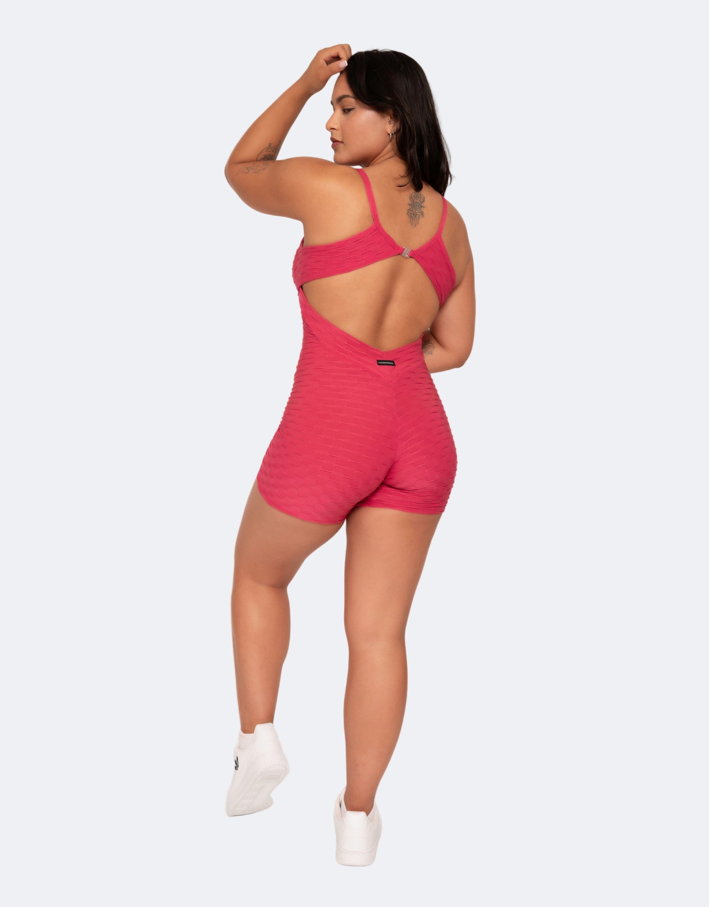 Amelia Pink Short Brazilian Jumpsuit showing cross-back strap design and sculpting fit, photographed from the back.