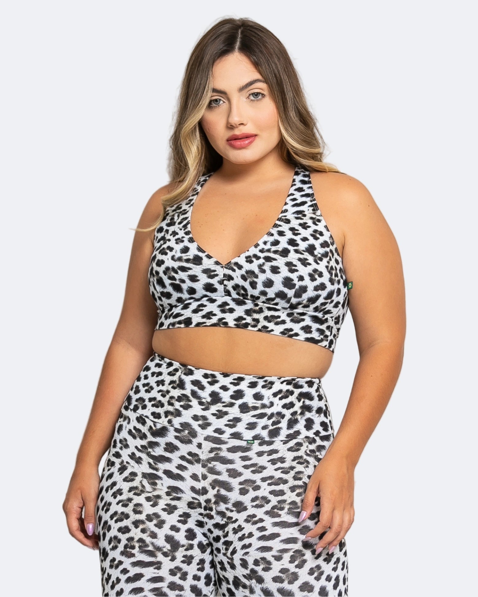 Woman wearing a leopard print two-piece set on a white background
