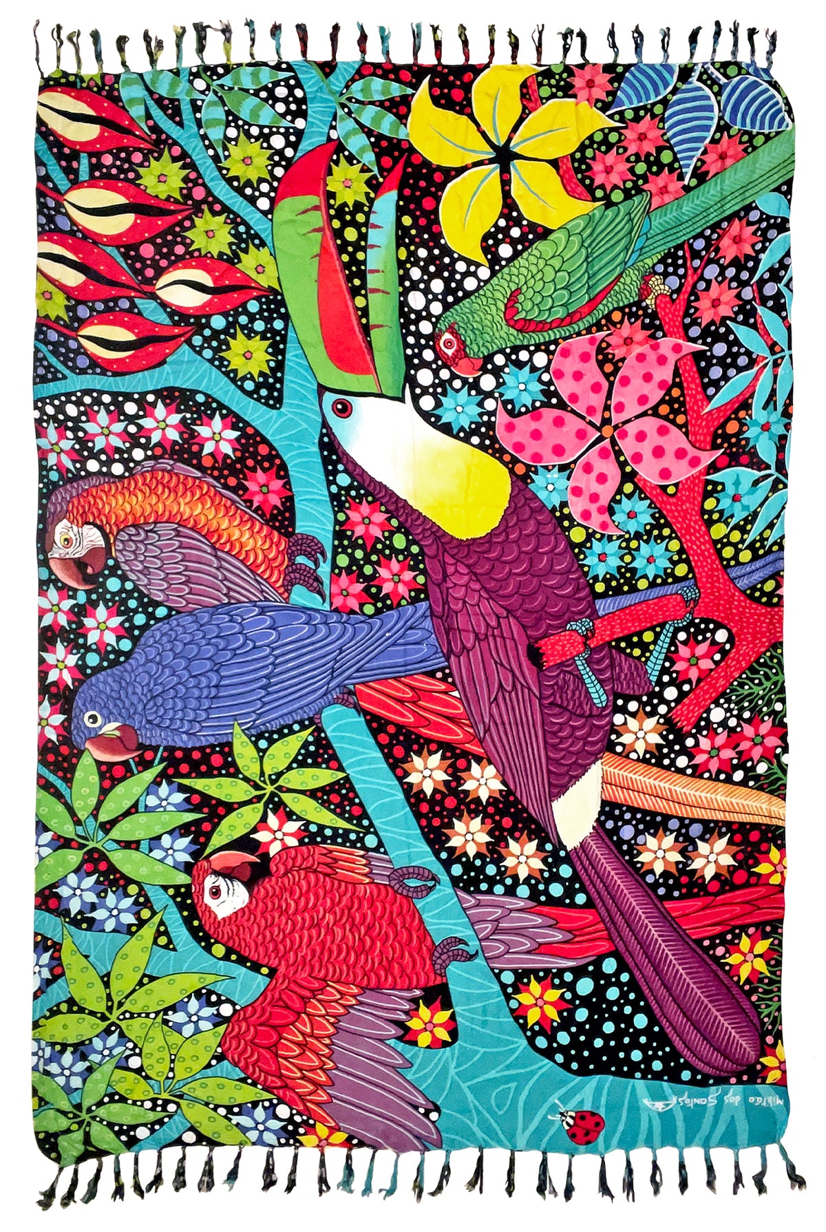 A square woven textile with black fringe on all sides, featuring a vivid, multicolored illustration of tropical birds, flowers, and leaves on a black background. The design includes a large purple toucan, red and blue parrots, green foliage, and bright floral motifs.