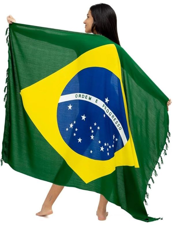 Person holding a Brazilian flag sarong with green, yellow, and blue colors.