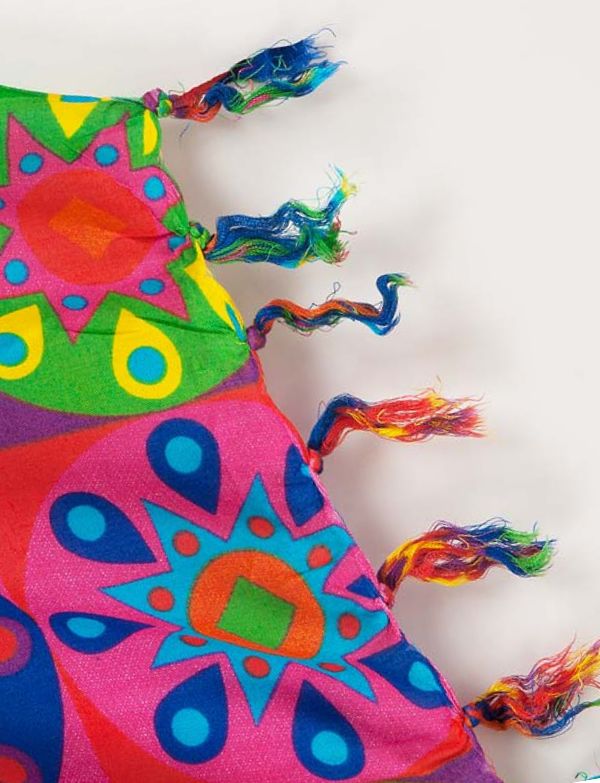 The image shows a sarong featuring a colourful, artistic depiction of a lion's face. Tasseled edge and showcases a vibrant, multicoloured lion design, which adds a unique and eye-catching element.