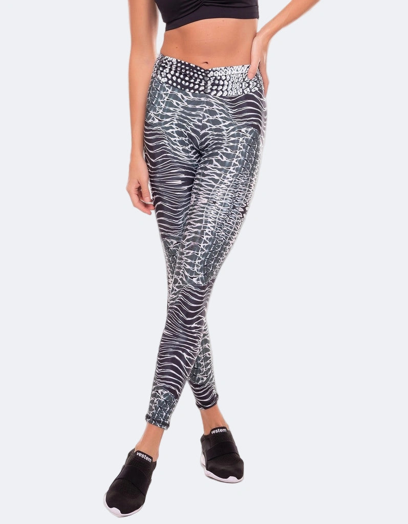 Person wearing black and white patterned leggings on a white background