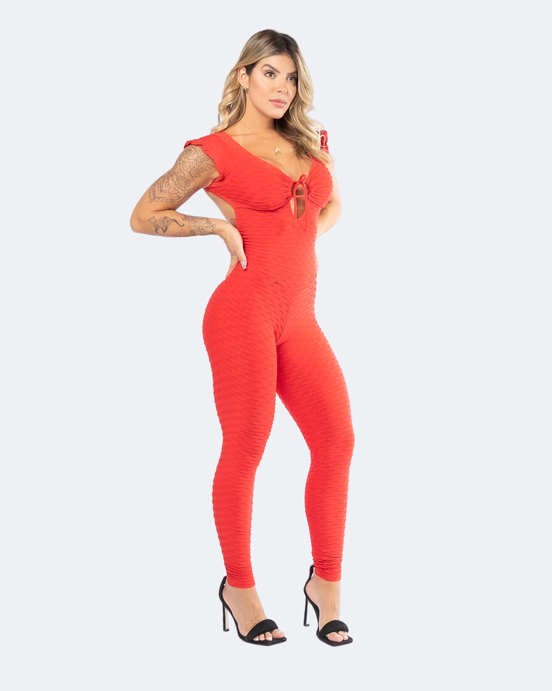 Woman wearing a red jumpsuit on a white background