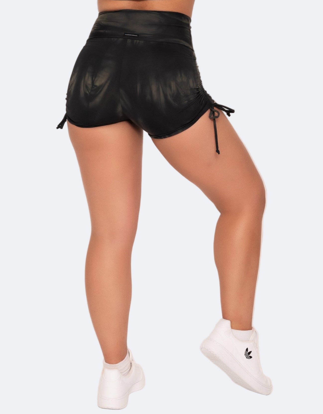 Black shorts worn by a person on a white background