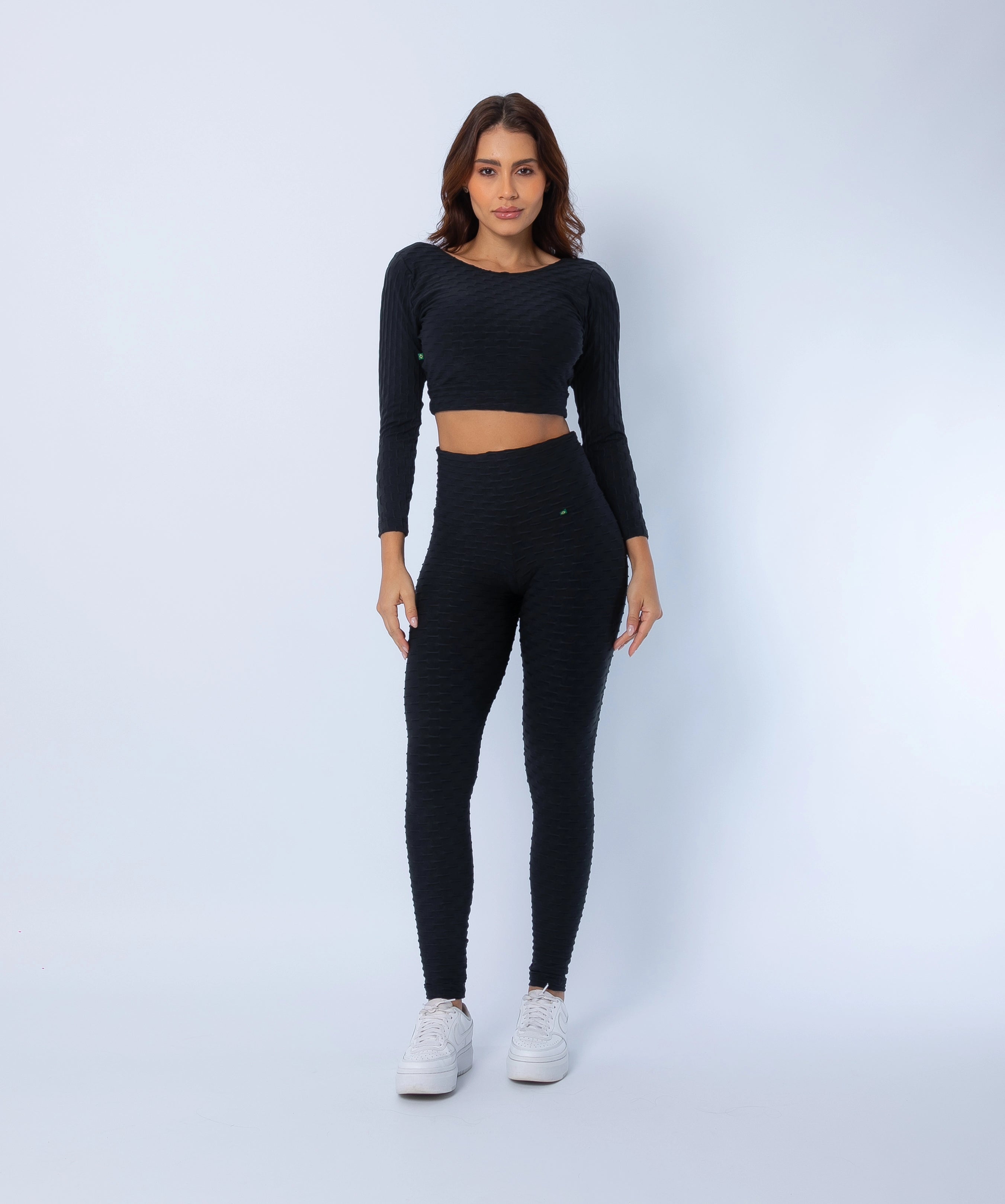 Fashion Brazil Luna Zero Flaws Scrunch Booty Leggings and Long Sleeve Crop Top, front view showing sculpting high-rise leggings with scrunch-back seam and sleek black textured fabric, paired with matching crop top.