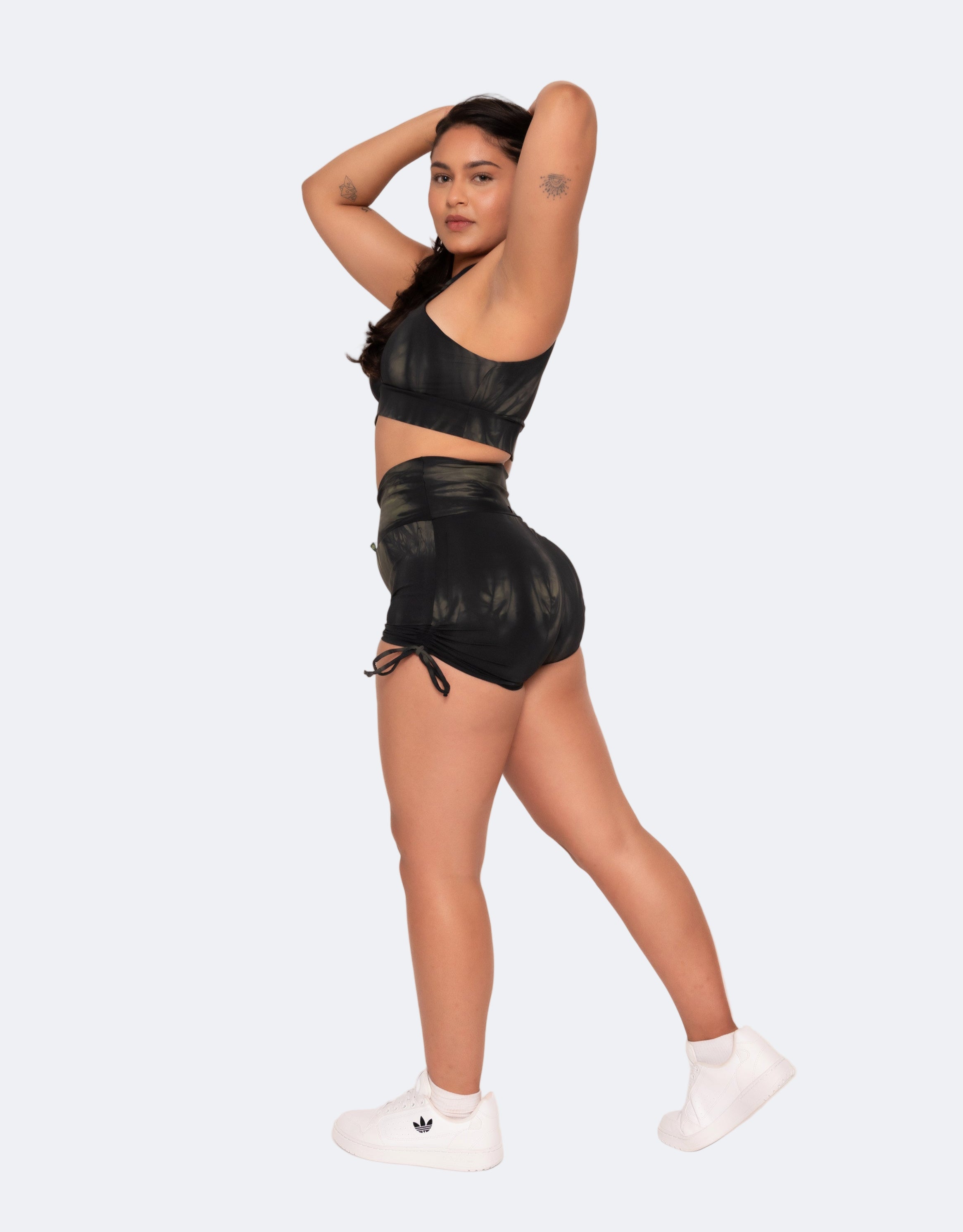 Side details of black tie-dye active set.  Active Crop featuring crisscross front and caped back design, made of smooth, stretchy fabric.