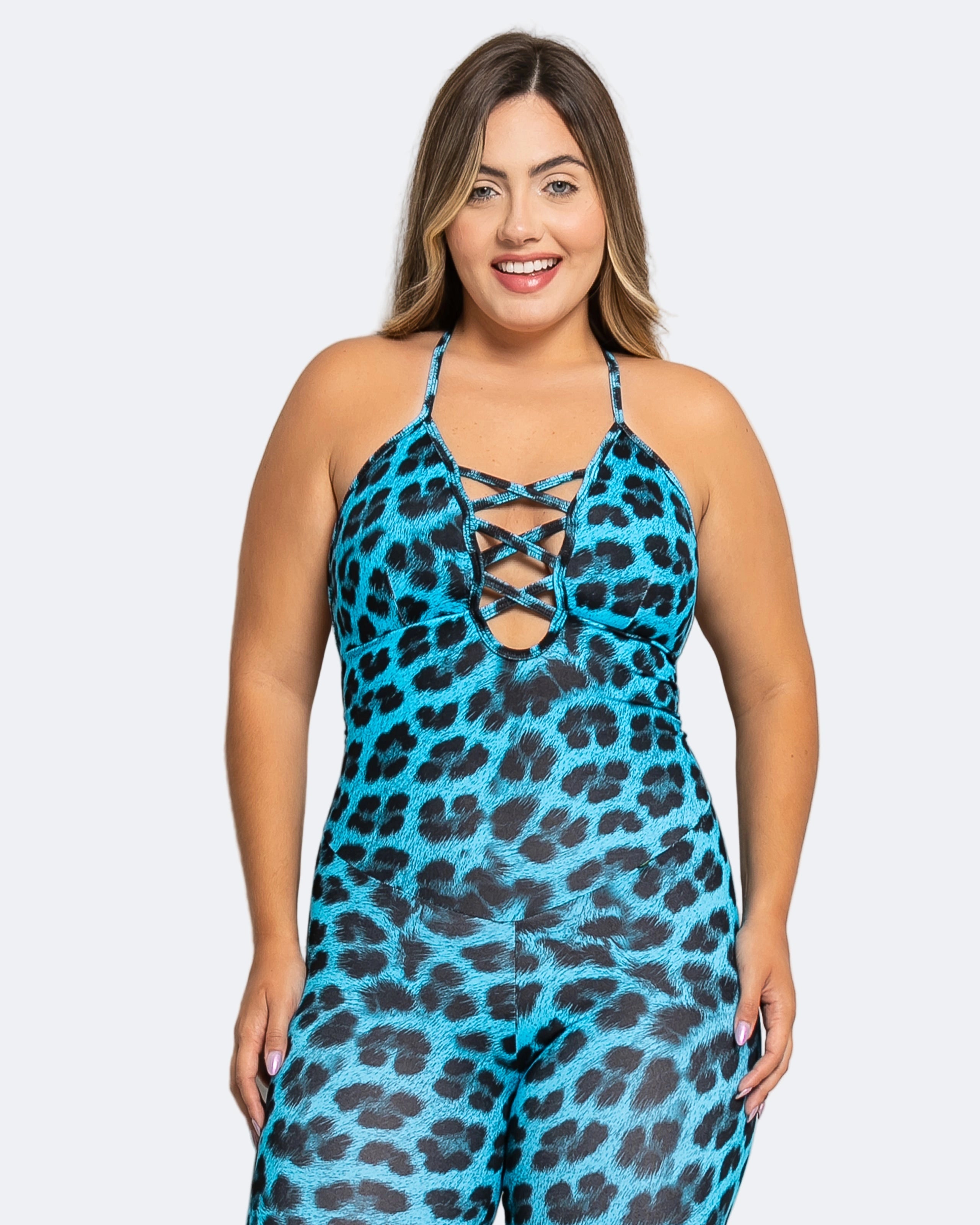 Woman wearing a blue leopard print jumpsuit on a white background