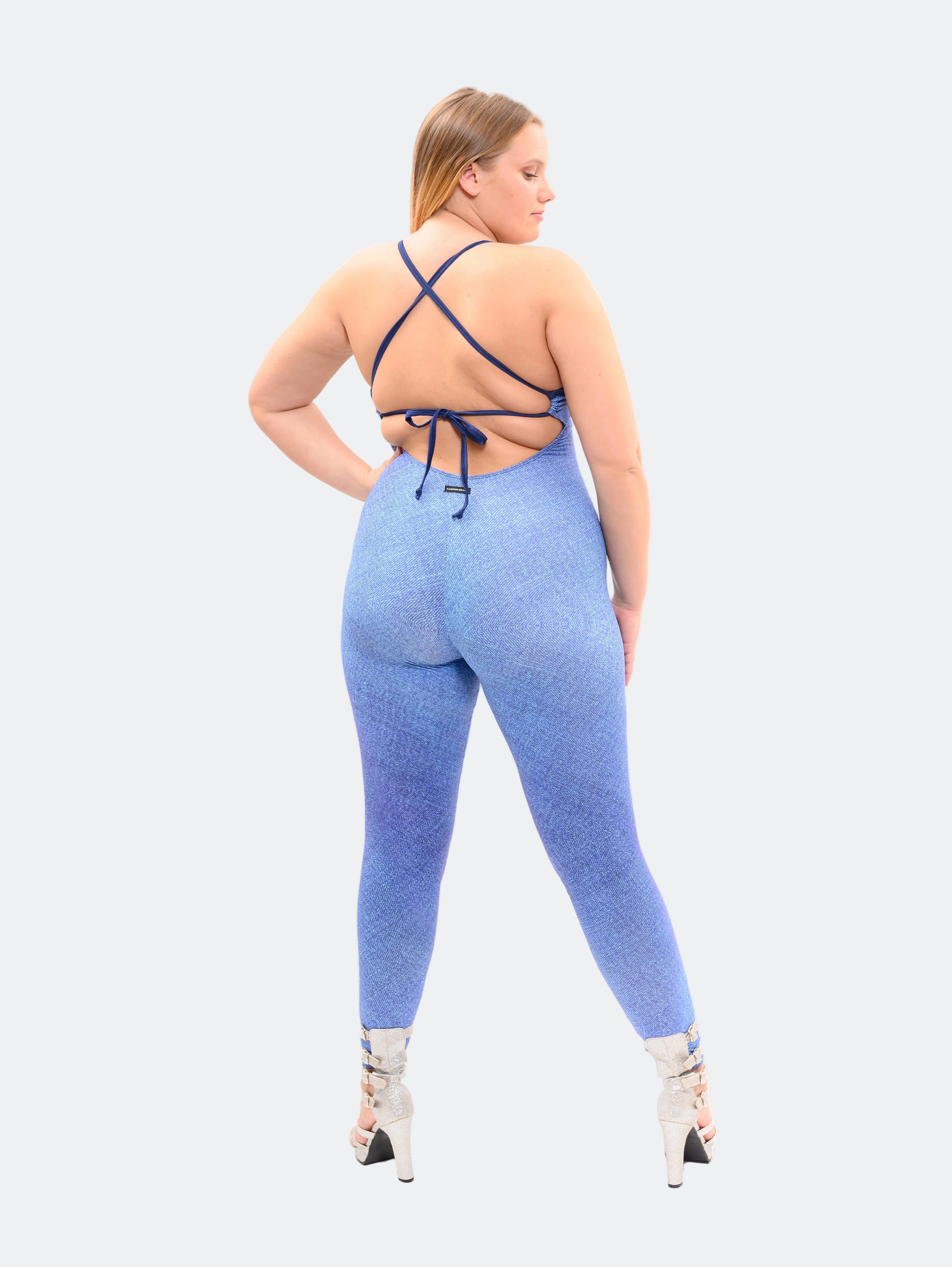 Woman wearing a blue ombre jumpsuit with criss-cross straps on a white background