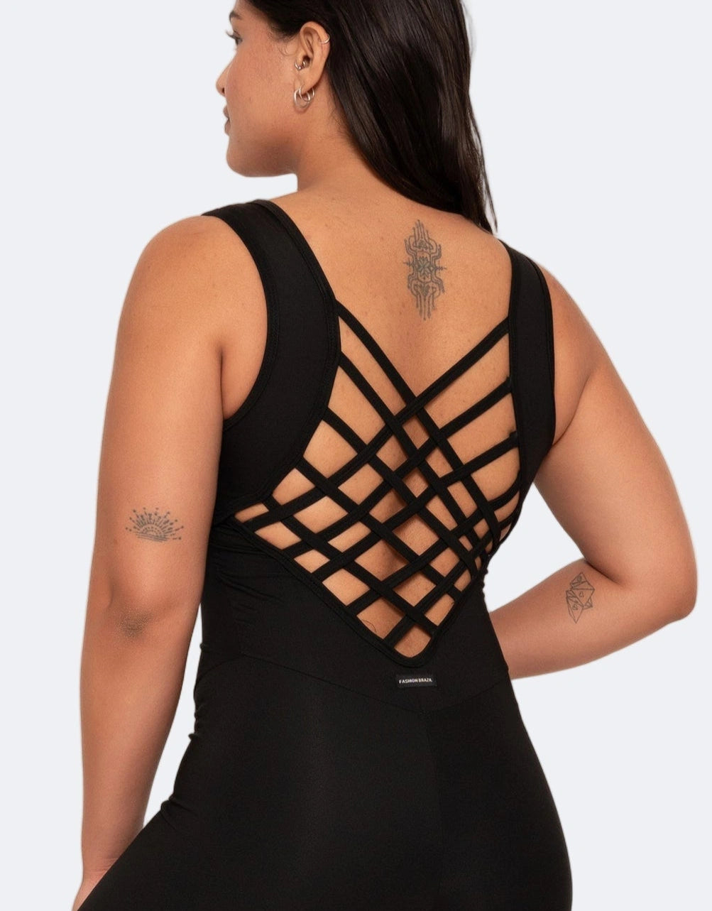 Black dress with criss-cross back design on a plain background