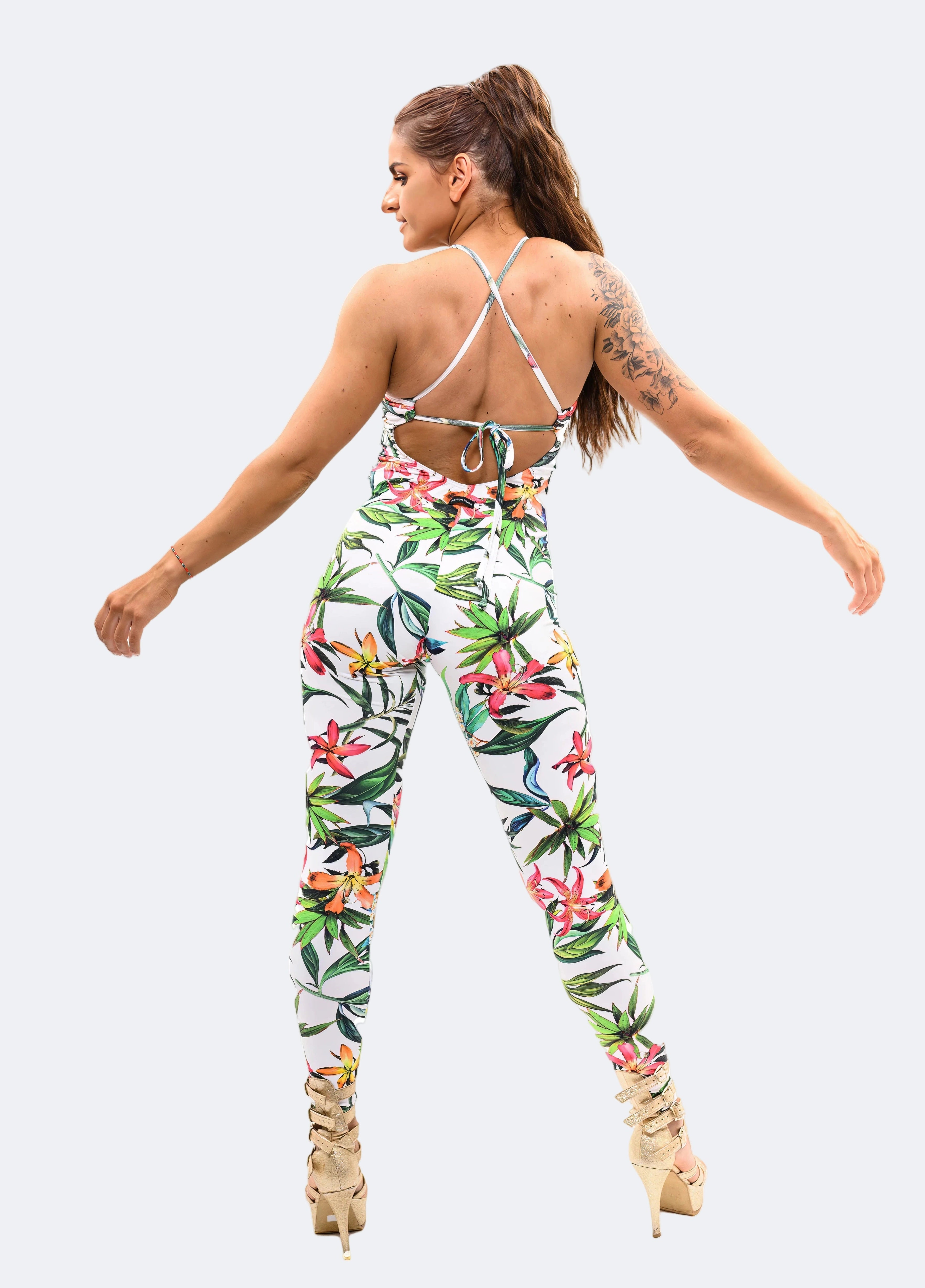 Woman wearing a floral jumpsuit on a white background