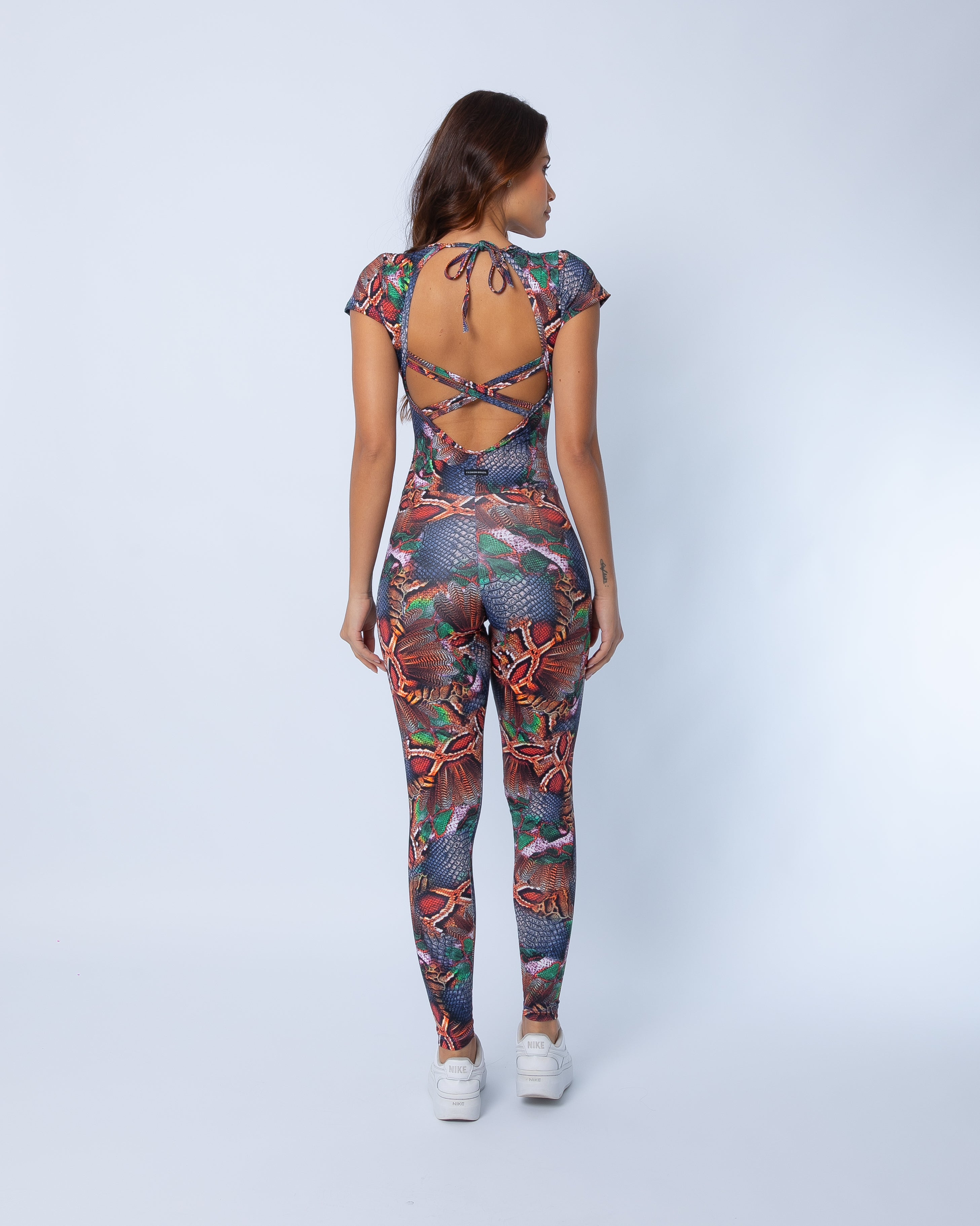 Fashion Brazil Copper Cobra Cap Sleeve jumpsuit back view, showing cap sleeves, curve-hugging fit, and copper, denim, and green snake-print pattern on a white background.