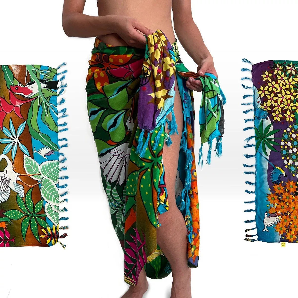 Woman wearing Pantanal Brazilian sarong draped as a skirt wrap showing white egret and tropical floral print – Fashion Brazil