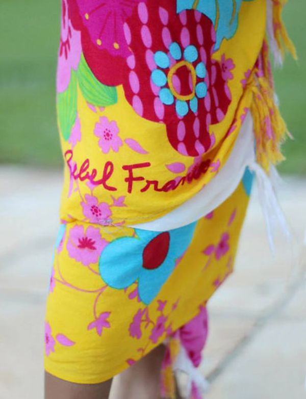 Pedra da Gávea sarong worn as a beach skirt wrap in yellow and pink tropical floral print on a green background — Fashion Brazil