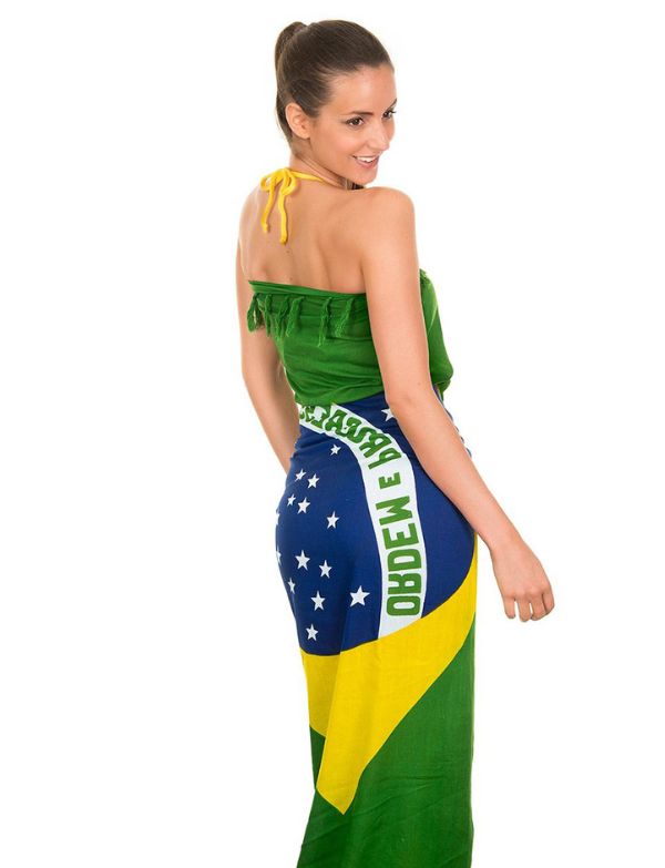 Person wearing a Brazilian flag sarong on a white background.