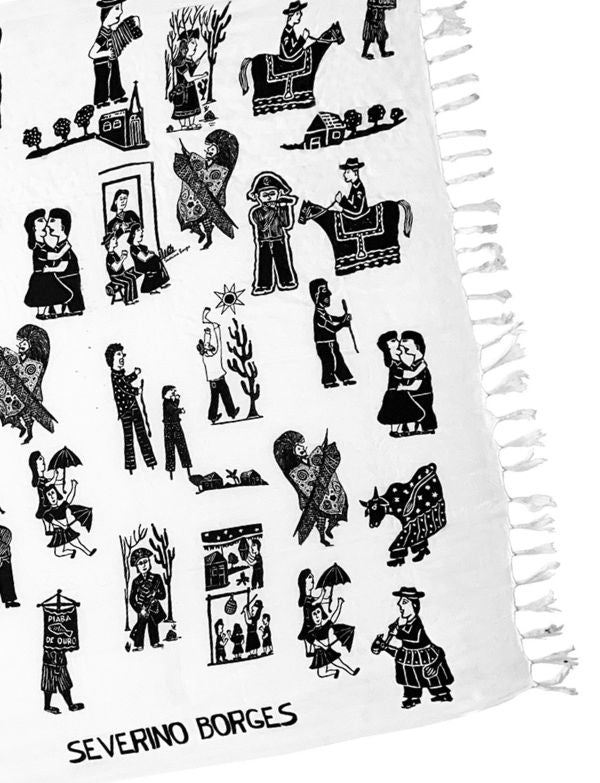 close up of black and white patterned sarong with 'Severino Borges' art on a white background