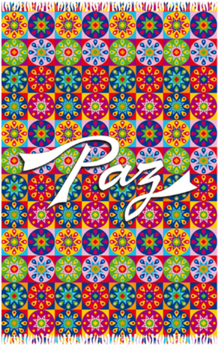 The sarong features a repeating pattern of stylised floral designs in a variety of colours, including red, blue, green, yellow, and purple. The word "Paz," which translates to "Peace" in Portuguese and Spanish, is written in a flowing white script across the center of the sarong. The edges of the sarong are finished with a fringe. 