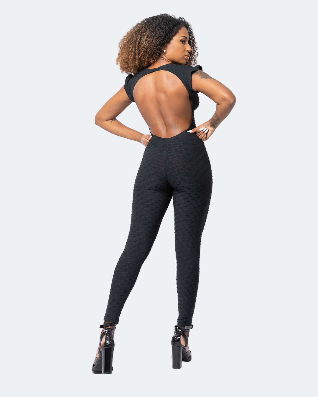 Fashion Brazil Valentina Black Jumpsuit back view highlighting open back design and sculpting full-length design in Zero Flaws textured fabric.